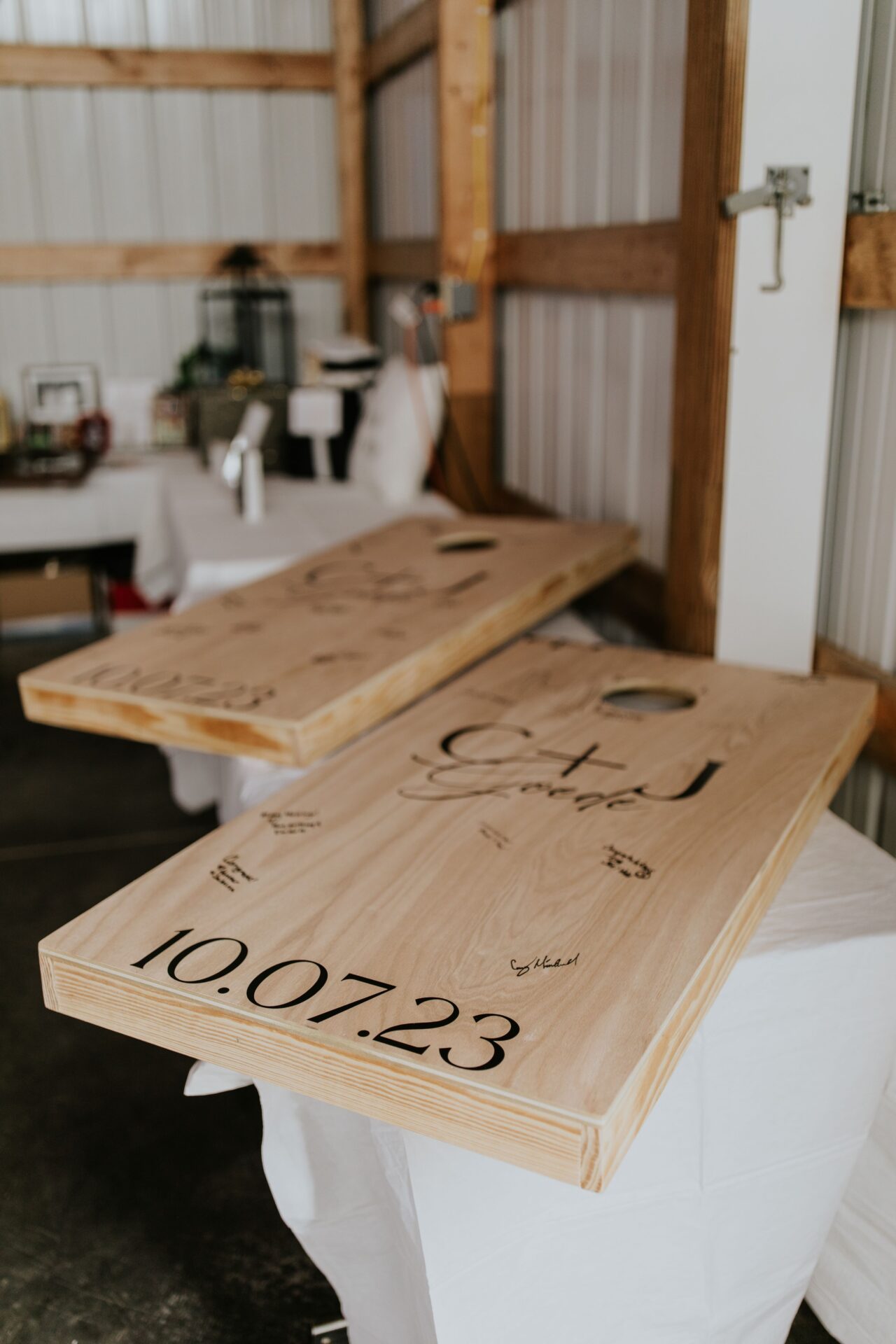 DIY wedding guest book. Customized bags boards on a reception table, being used as a wedding gustbook.